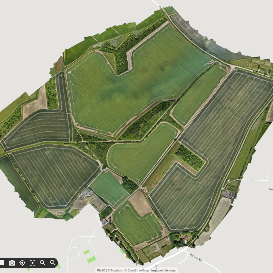RGB map Aerial view of vast agricultural fields and water bodies in a rural landscape.